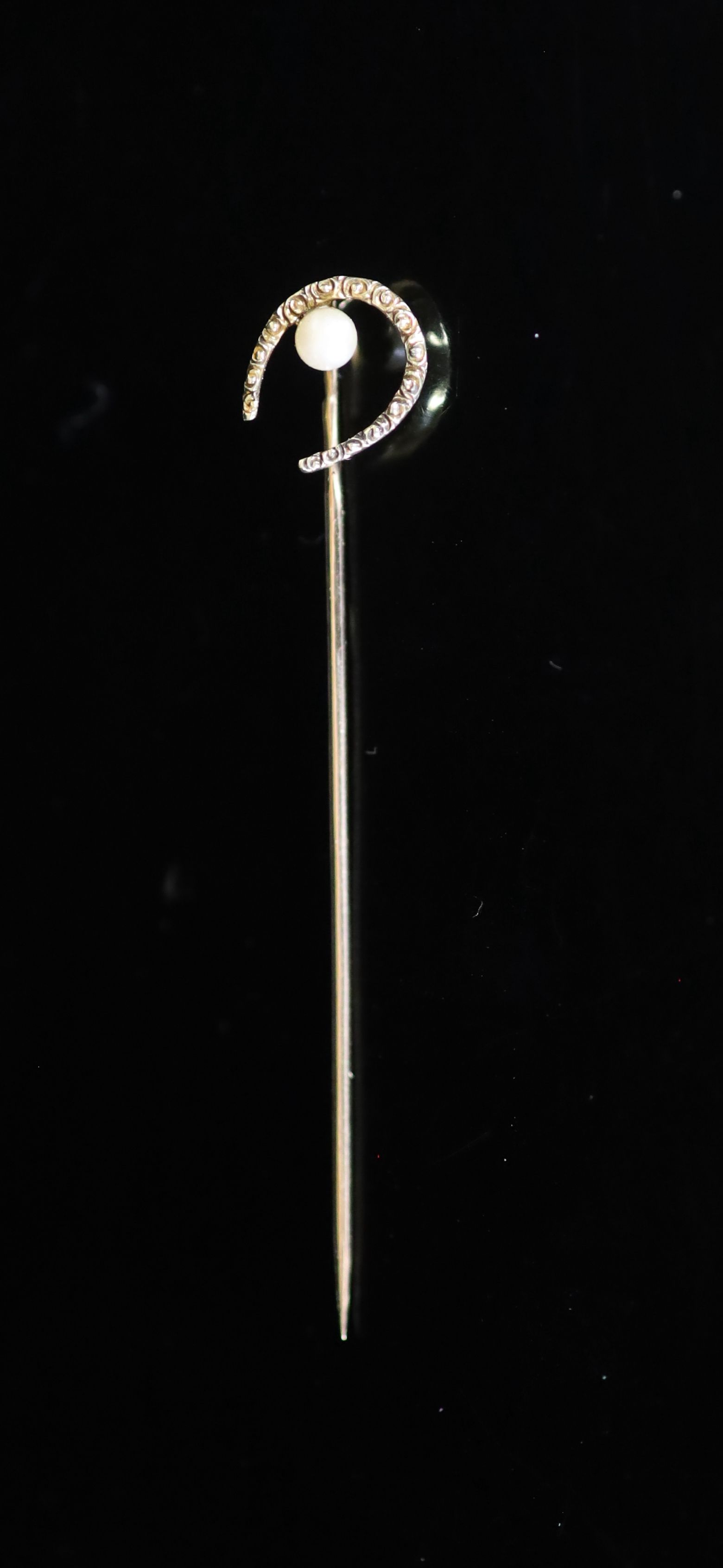 An early 20th century Russian 56 zolotnik gold and seed pearl set horseshoe stick pin by Faberge